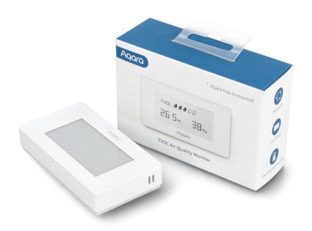 Biały czujnik jakości powietrza z wyświetlaczem leży na białym tle wraz z pudełkiem.